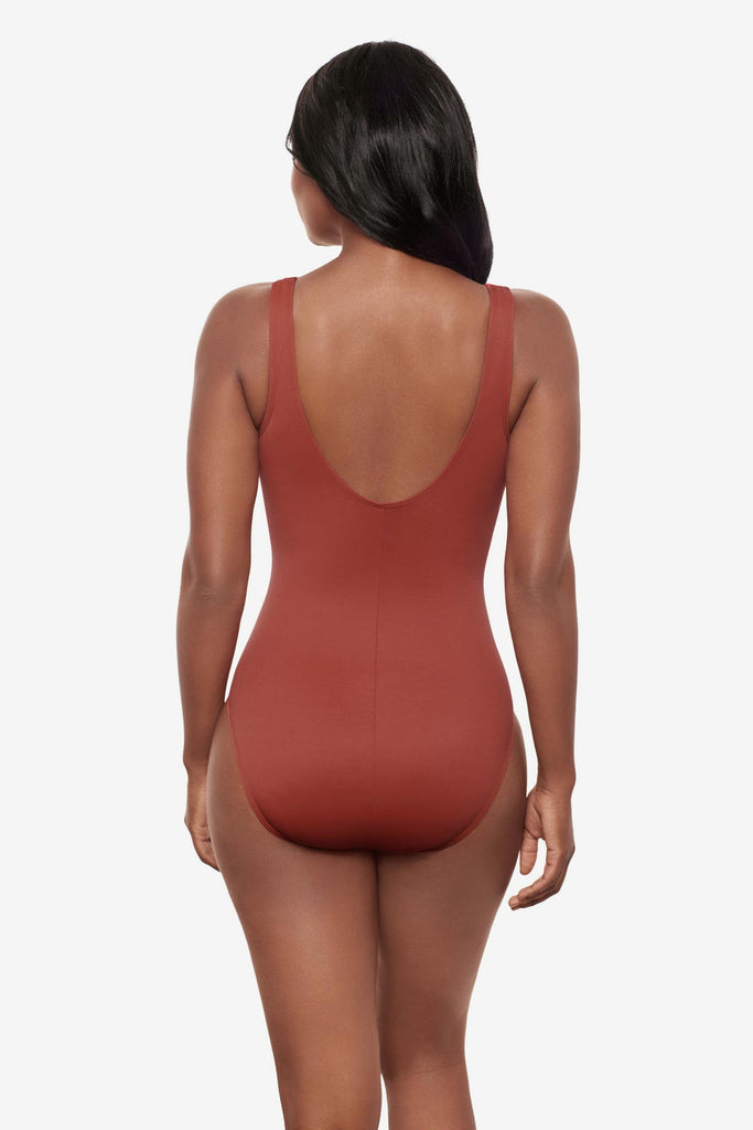 Woman turned away wearing a brown one-piece swimsuit