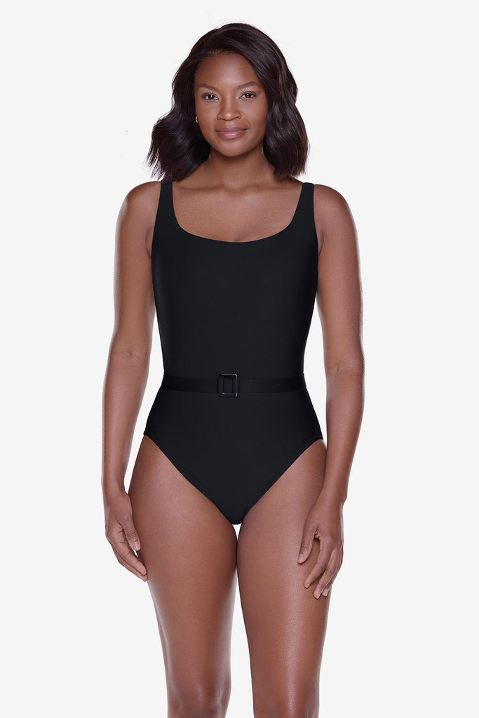 Woman wearing a black one-piece swimsuit with belt detail